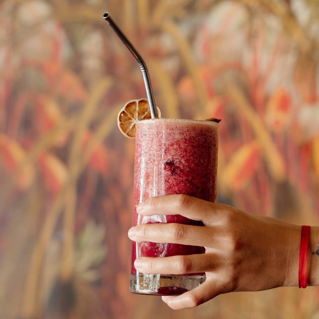 holding fruit smoothie
